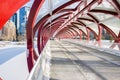 Lonely Person walking along a Steel Covered Bridge on a Winter Day