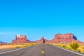 Lonely person walking along the road in Monument Valley, Utah, USA Royalty Free Stock Photo