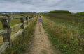 Lonely person walking on a road in the countryside