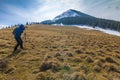 Lonely photographer in mountains with a camera on a tripod in co