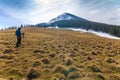 Lonely photographer in mountains with a camera on a tripod in co