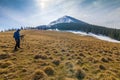 Lonely photographer in mountains with a camera on a tripod in co