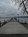 Lonely pier under cloudy sky