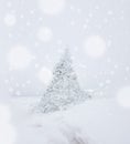 Lonely pine tree in heavy snow fall middle of winter