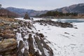 Lonely Pine tree on rock on Altai river Katun in winter. Rocks called Dragon\'s teeth, Dragon crest, or Sartakpai Arrows