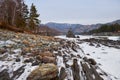 Lonely Pine tree on rock on Altai river Katun in winter. Rocks called Dragon\'s teeth, Dragon crest, or Sartakpai Arrows