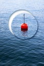 Lonely plastic red bouy on a calm lake - concept image Royalty Free Stock Photo