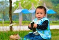 Lonely play mobile phone baby(Asia, China, Chinese) Royalty Free Stock Photo