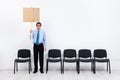 Lonely protesting businessman or employee holding placard