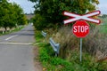 Lonely railway stop sign with cross in the day light Royalty Free Stock Photo