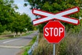 Lonely railway stop sign with cross in the day light Royalty Free Stock Photo