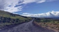 Lonely and remote rugged road, Piilani Hwy past Hana around south of Maui with Haleakala mountain, ocean and clouds in background Royalty Free Stock Photo