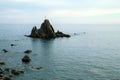 The lonely rocky island with a simple cross