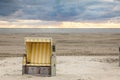 Lonely roofed wicker beach chairs at a beach at Langeoog at the north sea in the evening Royalty Free Stock Photo