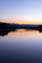 Lonely rowing boat sports in long canal training in calm sunset water with reflections and vibrant colors in Plovdiv, Bulgaria Royalty Free Stock Photo