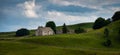 Lonely run down farm house on the aubrac plateau Lozere france. with cloudy skys