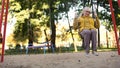 Lonely sad old woman riding on swing in park, no friends and family, abandoned Royalty Free Stock Photo