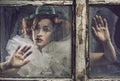 A lonely sad pierrot woman behind the glass Royalty Free Stock Photo