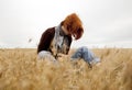 Lonely sad red-haired girl at field