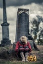 Lonely Sad Young Woman in Mourning in front of a Gravestone Royalty Free Stock Photo