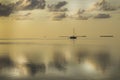 A lonely sailboat in the middle of the ocean at sunset in Keys, Florida.