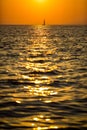 Lonely sailboat in the sea during a beautiful sunset Royalty Free Stock Photo