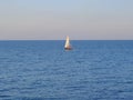 Lonely sailboat in the sea under blue sky Royalty Free Stock Photo