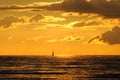 Lonely sailboat in warm evening light at sunset Royalty Free Stock Photo
