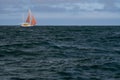 Lonely Sailing boat on blue open sea. Concept of loneliness, solitude and desolation