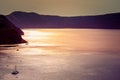 Lonely sailing boat in the vastness of aegean sea, Santorini.