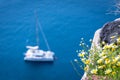 Lonely sailing boat in the vastness of aegean sea, Santorini. Royalty Free Stock Photo