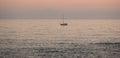 Lonely sailing yacht on ocean at dusk