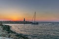 A lonely sailingboat returning to the harbour in Tel Aviv at sunset Royalty Free Stock Photo