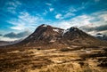 Lonely Scottish House under a snow-capped mountain Royalty Free Stock Photo