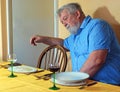 Lonely senior man at the dinner table. Bereavement. Royalty Free Stock Photo