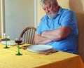 Lonely senior man at the dinner table.