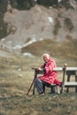 Lonely senior man sitting on bench being absorbed into his thoughts Royalty Free Stock Photo