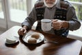 Lonely senior man sitting at kitchen table drinking tea Royalty Free Stock Photo