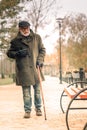 A lonely senior man walking in park experiencing chest pain Royalty Free Stock Photo