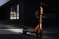Lonely shared electric kick scooter illuminated by the sun in Melbourne