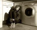 Lonely and sick woman sitting on kitchen floor in stress depression and sadness