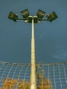 Lonely stadium light or lamp post with Union of light bulb stand alone with clould and blue sky Royalty Free Stock Photo