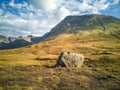 Lonely stone next to the Fairy Pools in front of the Black Cuillin Mountains on the Isle of Skye - Scotland Royalty Free Stock Photo