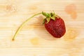 Lonely strawberry on a chopping board Royalty Free Stock Photo