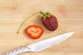 Lonely strawberry on a chopping board Royalty Free Stock Photo