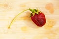 Lonely strawberry on a chopping board Royalty Free Stock Photo