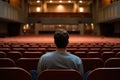 Lonely student in dim university lecture hall Royalty Free Stock Photo