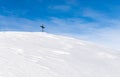 Lonely Summit Cross on windswept snow mountain with blue Sky. Rangiswanger Horn, Alps, Allgau, Bavaria, Germany. Royalty Free Stock Photo