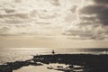 Lonely surfer look at the ocean under a great cloudy sky Royalty Free Stock Photo