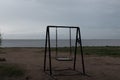 a lonely swing on the background of the gulf Royalty Free Stock Photo